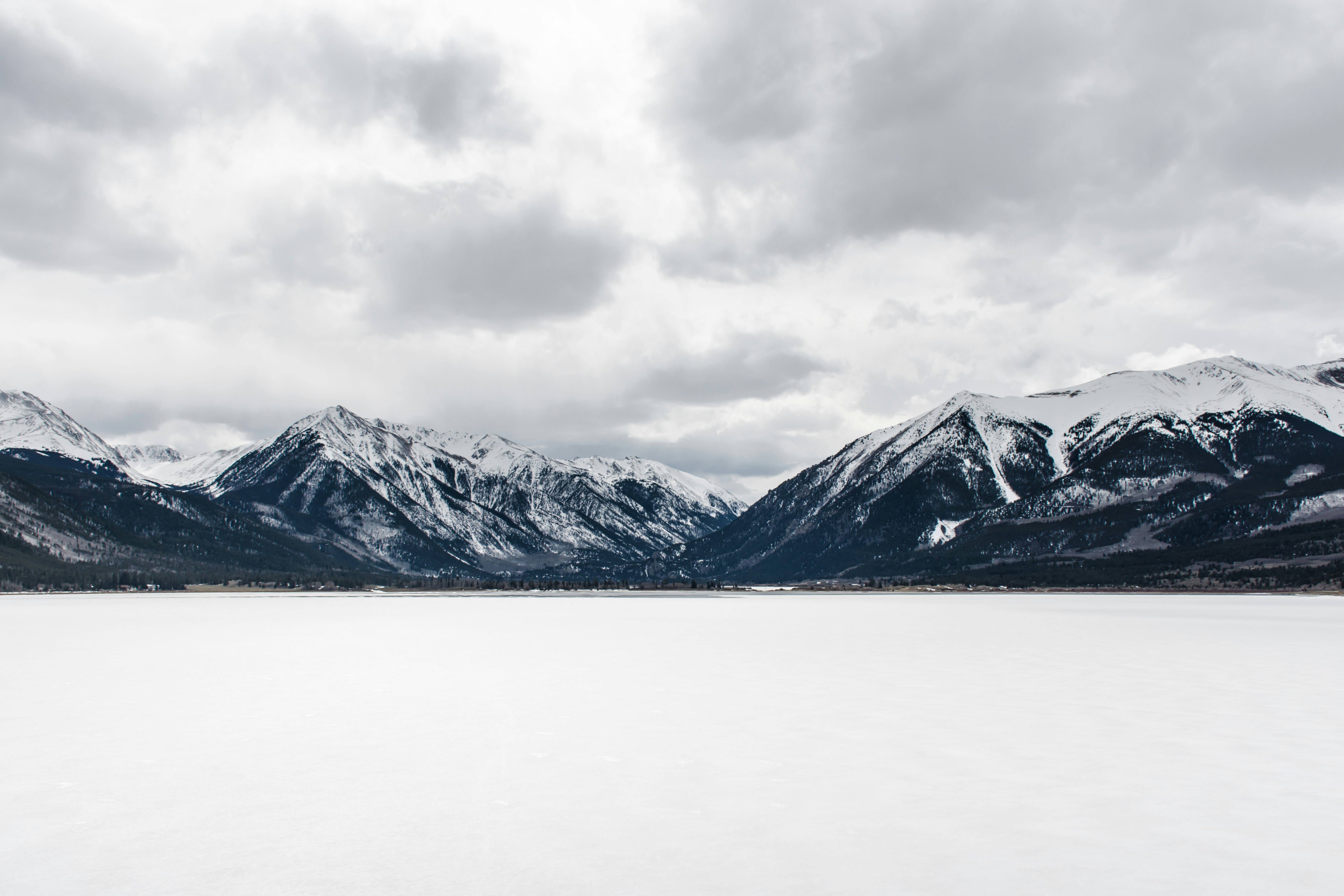 body of water near mountain peak during daytime